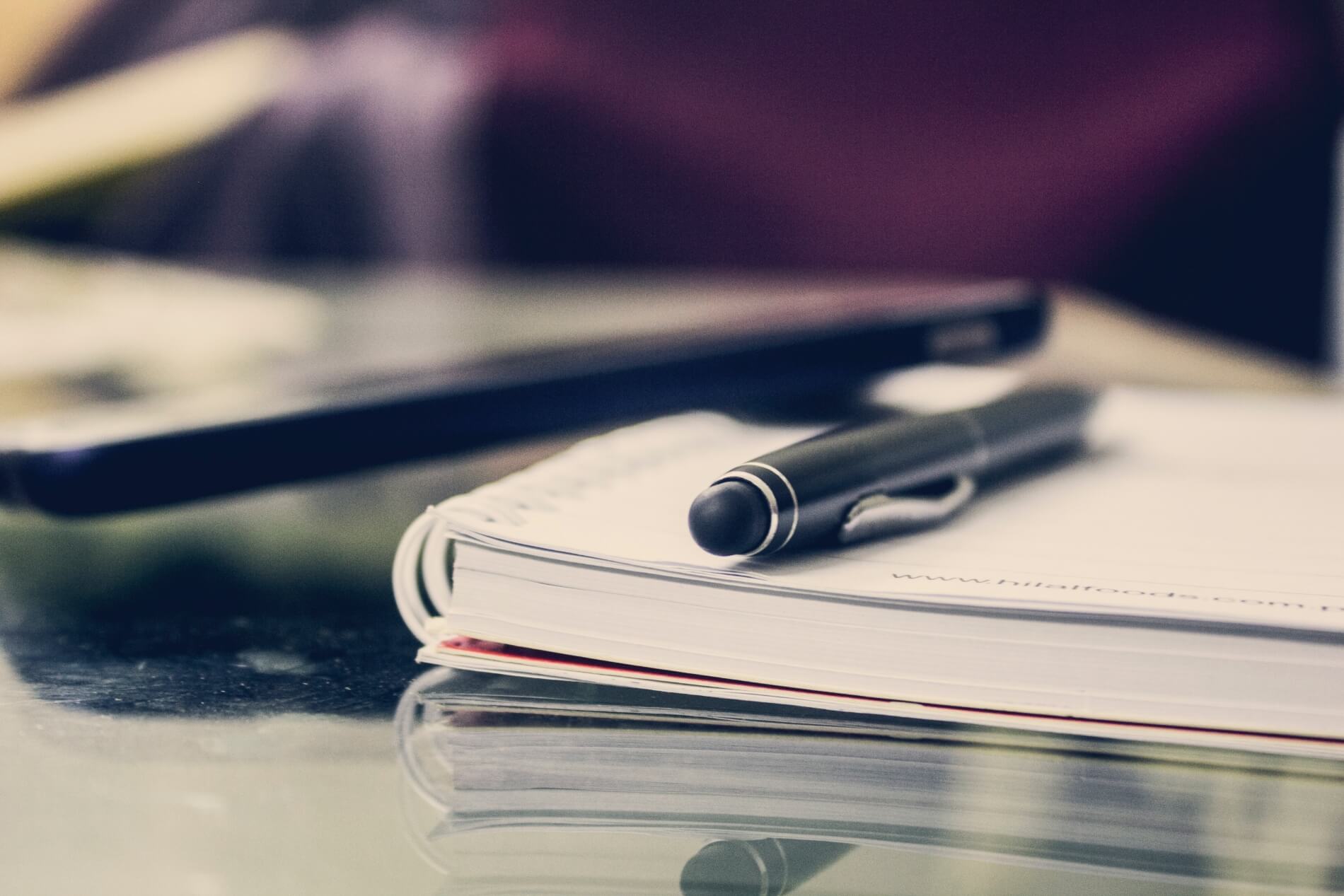 Notebook with a pen on a desk