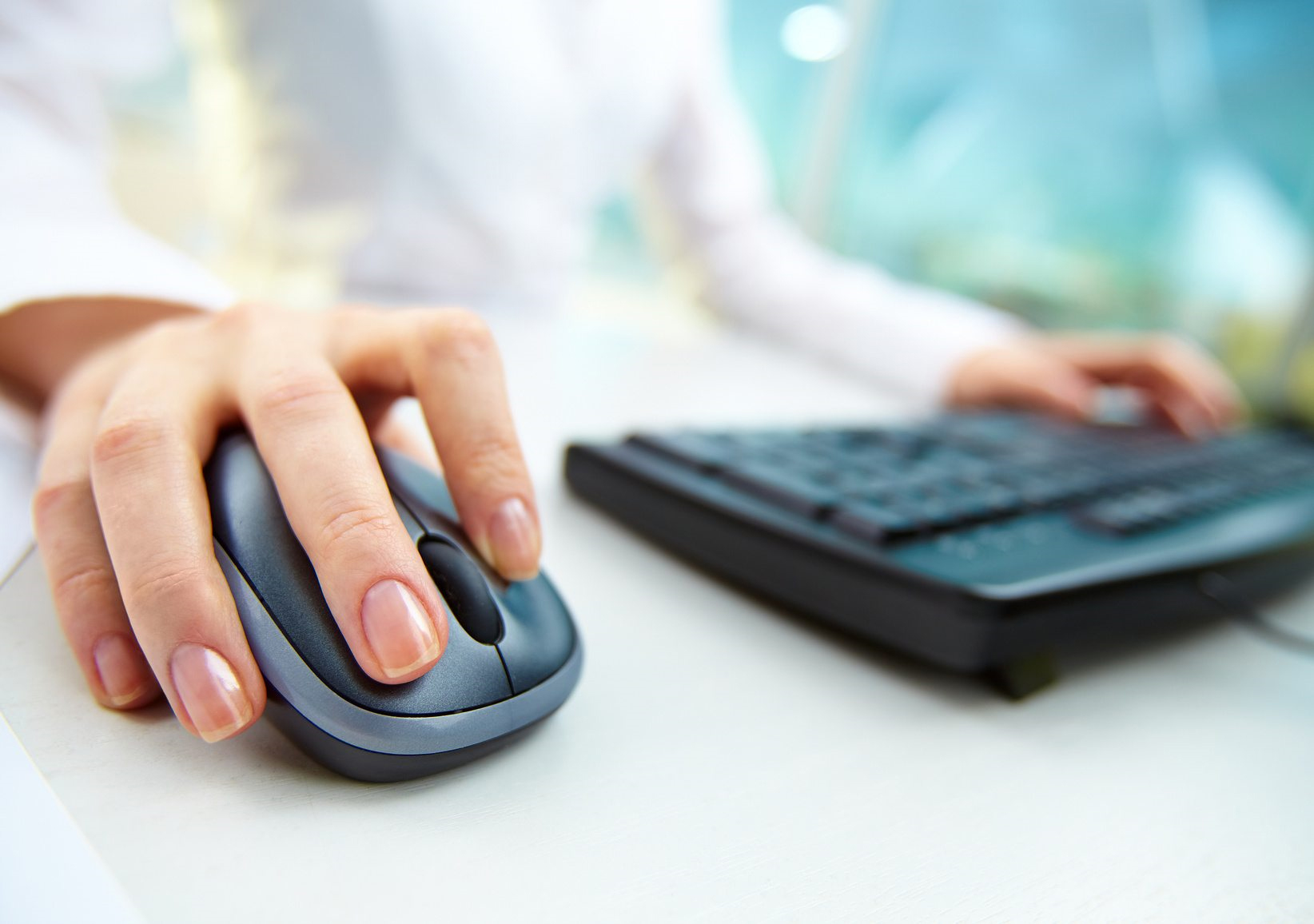 A person using a mouse and keyboard