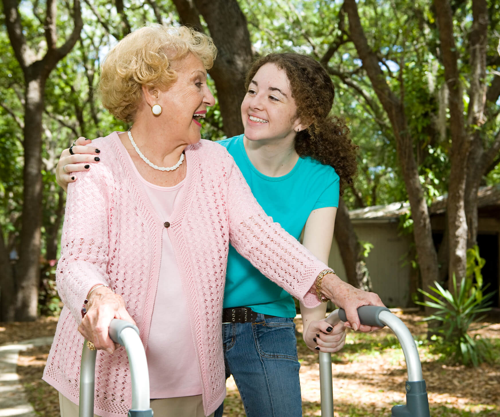 A girl helping older woman with a walking aid