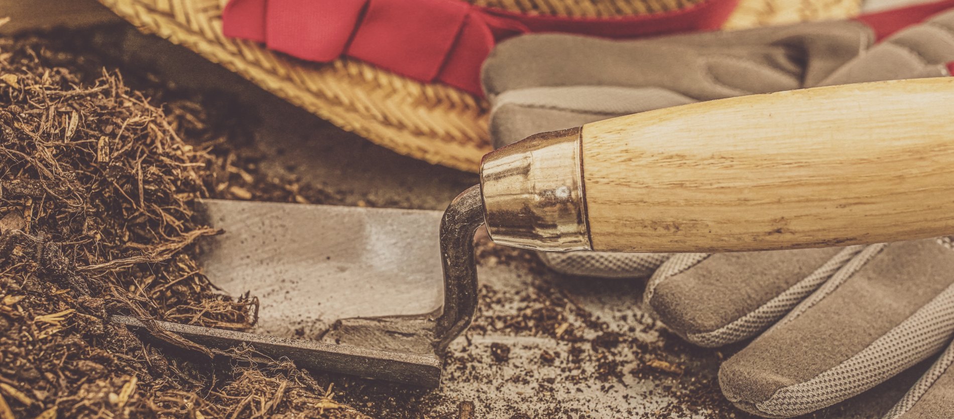 Hand garden shovel with gloves, hat and garden soil