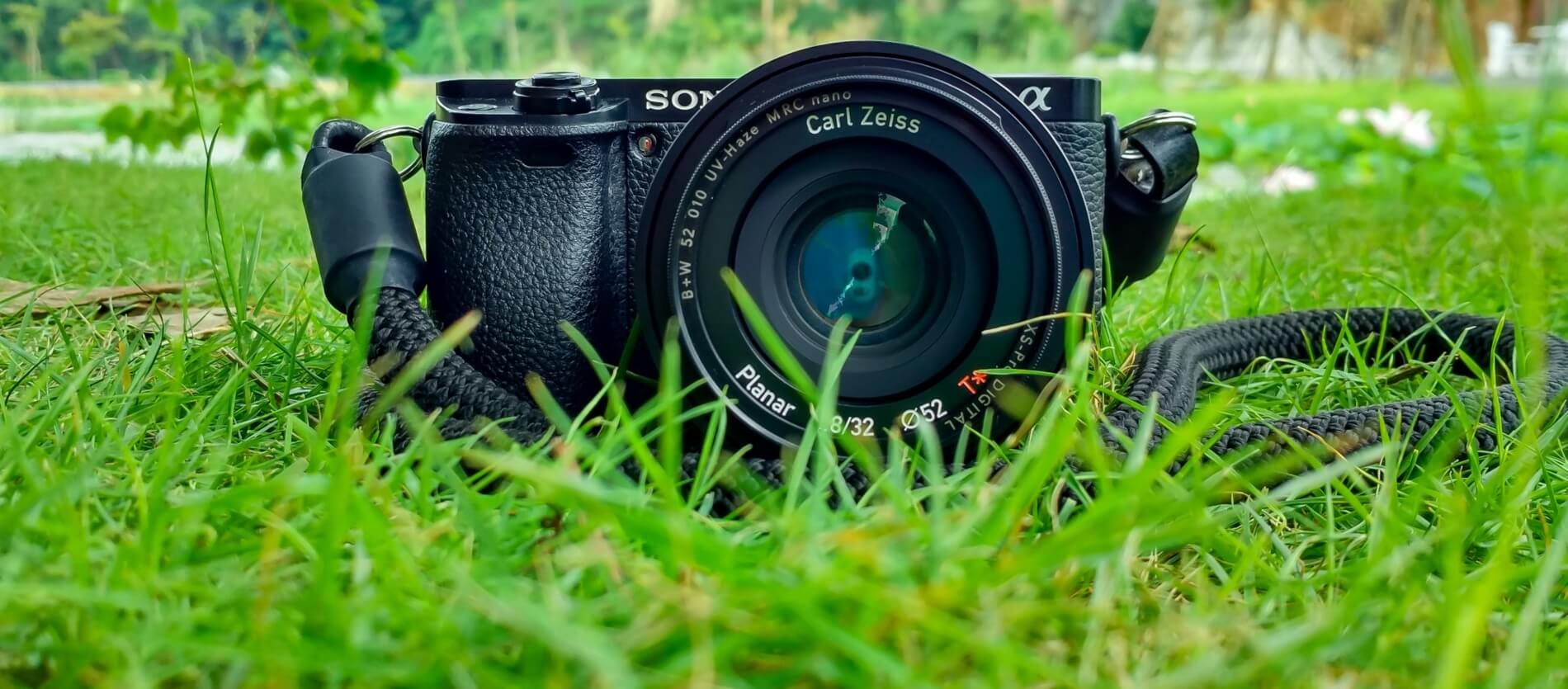 Black Sony Dslr Camera on Green Grass in Front of Brown and Green Mountain (Fox|Pexels)