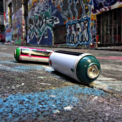 View of spray paint can and graffiti
