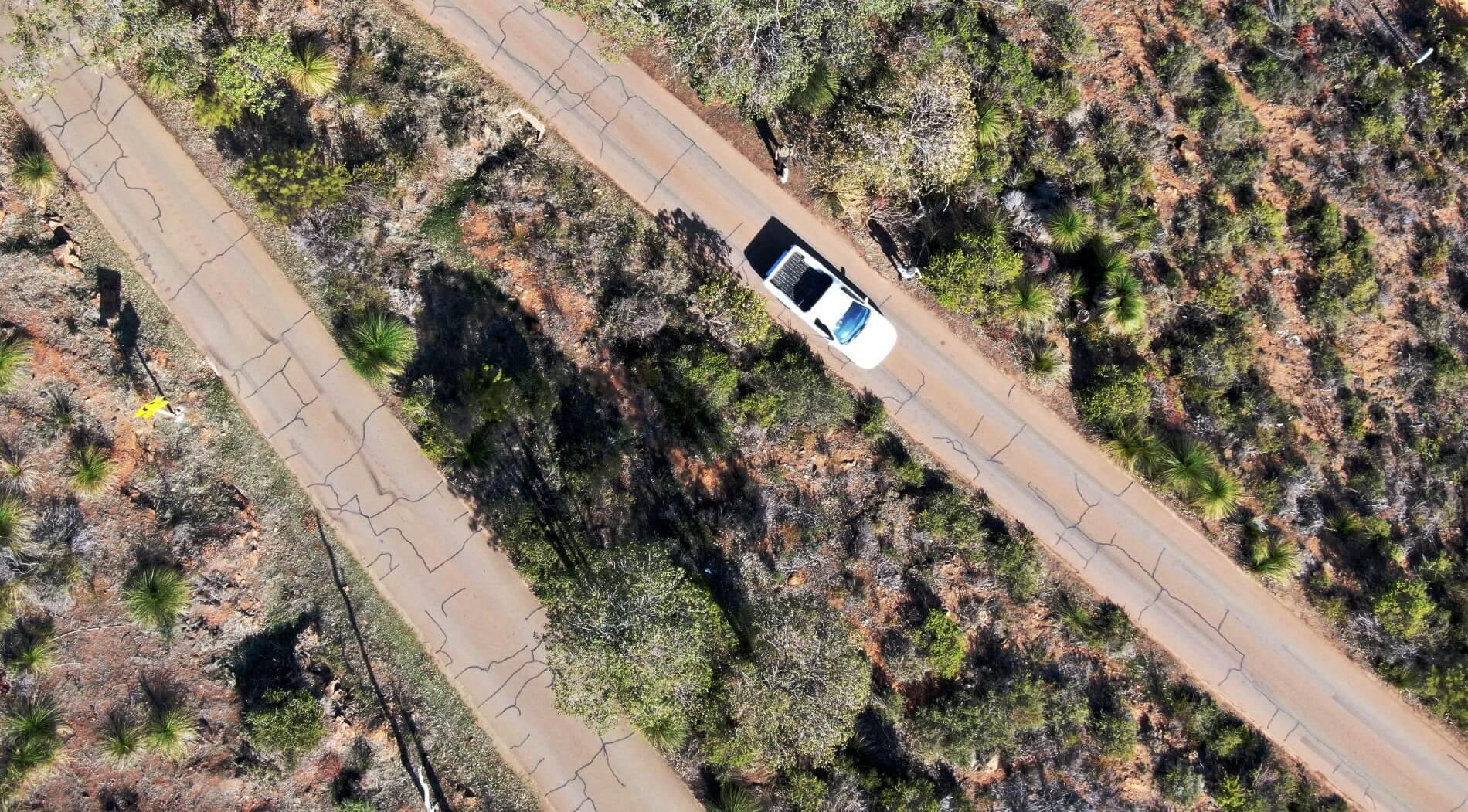 Aerial view of a white vehicle travelling down the Zig Zag Scenic Drive.